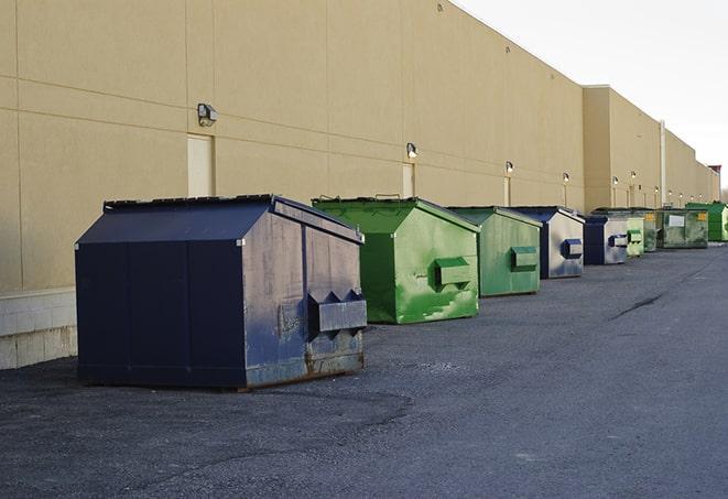 a row of heavy-duty dumpsters ready for use at a construction project in Crockett, TX